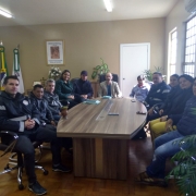 Onze pessoas sentadas em volta de uma mesa.